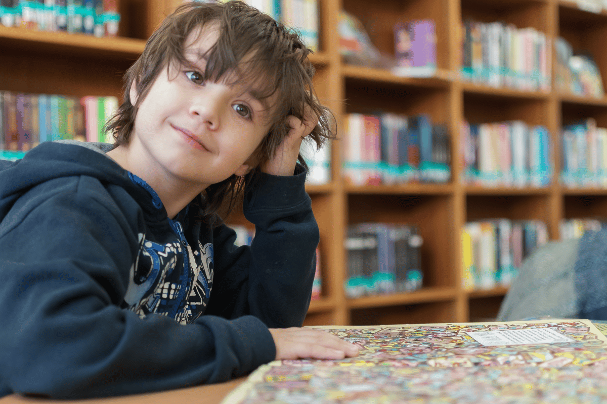 kid sitting in a library