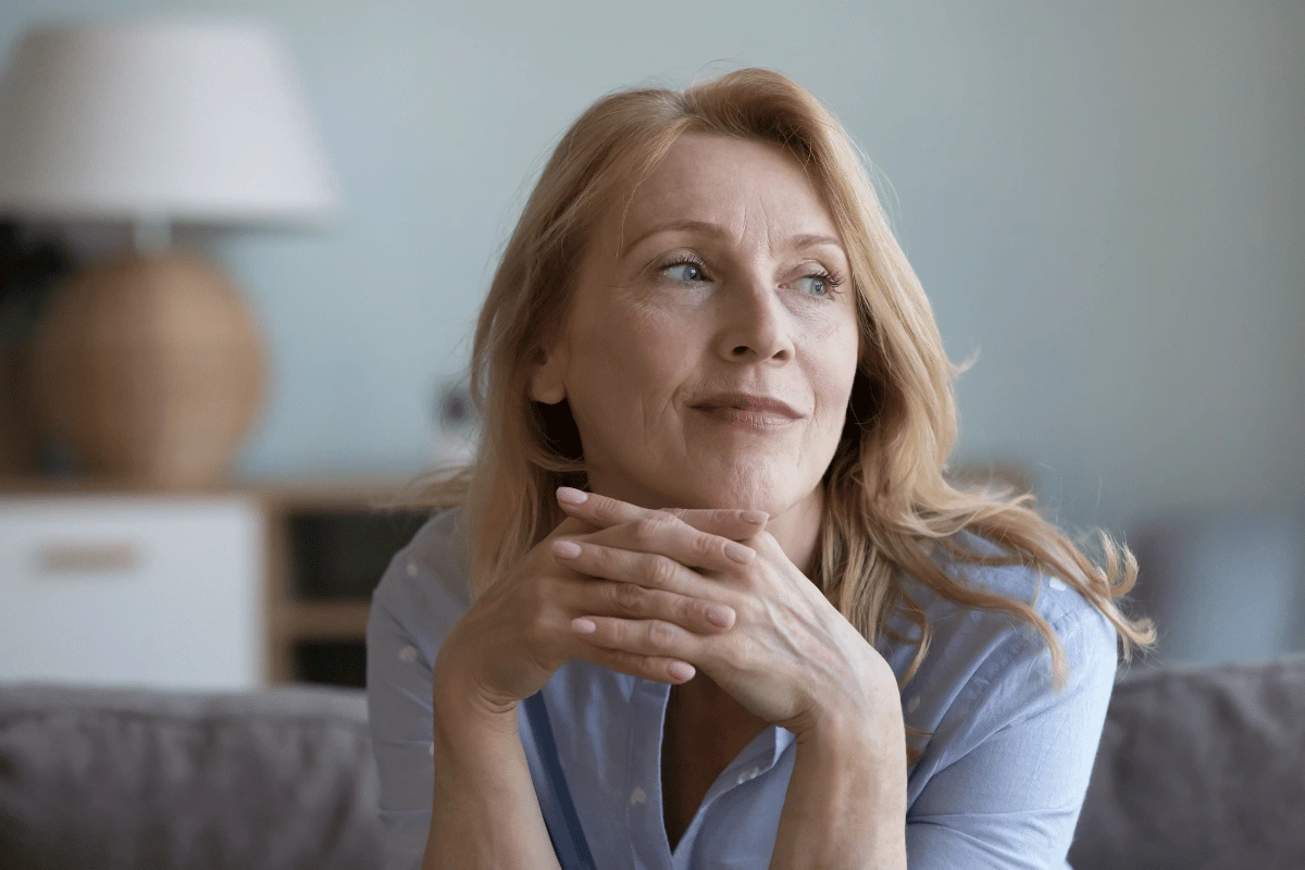 an older woman sitting on her couch at home